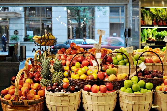 a bunch of baskets filled with different types of fruit